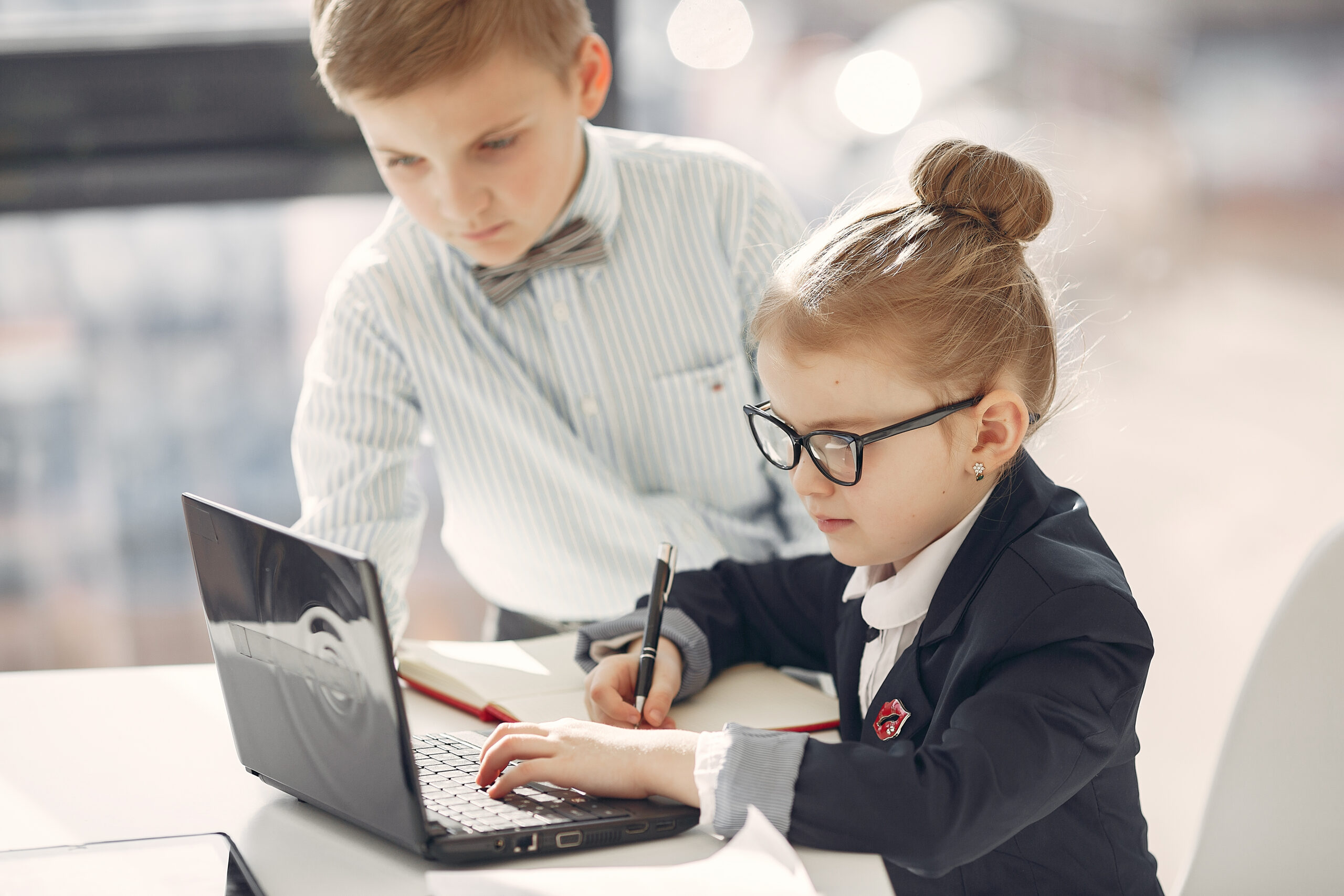 Business theme. Children in a business style. Kid with a laptop.